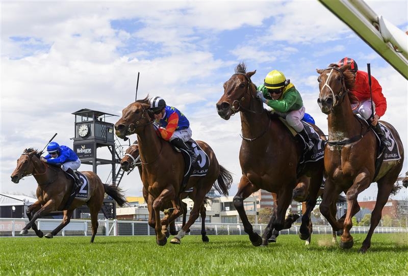 MELBOURNE, AUSTRALIA - OCTOBER 09: Luke Currie riding Savatoxl (ctr) defeats Michael Dee riding Dosh in race 5,  the Lexus Schillaci Stakes, during Melbourne Racing at Caulfield Racecourse on October 09, 2021 in Melbourne, Australia. (Photo by Vince Caligiuri/Getty Images)