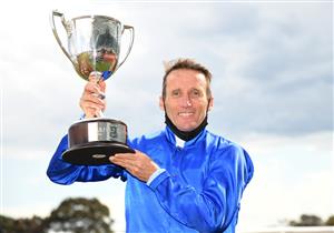 MELBOURNE, AUSTRALIA - OCTOBER 09: Damien Oliver poses with the trophy after riding Anamoe to win in Race 8, the Neds Caulfield Guineas, winning during Melbourne Racing at Caulfield Racecourse on October 09, 2021 in Melbourne, Australia. (Photo by Vince Caligiuri/Getty Images)