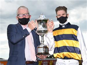 MELBOURNE, AUSTRALIA - OCTOBER 09: Trainer Mick Price and Jye McNeil pose with the trophy after I