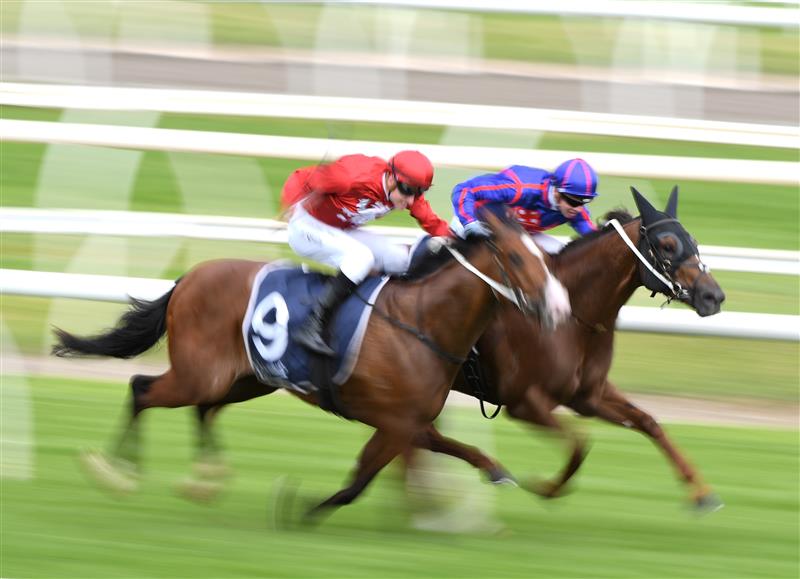MELBOURNE, AUSTRALIA - OCTOBER 13: Zac Spain riding Extreme Warrior (red) defeats Jye McNeil riding Profiteer in race 6, the Catanach's Jewellers Blue Sapphire Stakes at Caulfield Racecourse on October 13, 2021. (Getty)