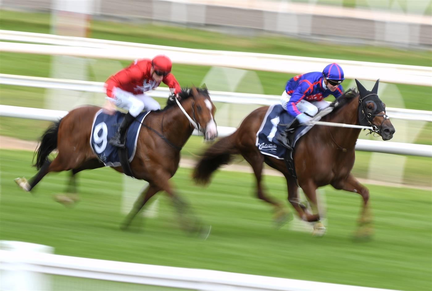 MELBOURNE, AUSTRALIA - OCTOBER 13: Zac Spain riding Extreme Warrior (red) defeats Jye McNeil riding Profiteer in race 6, the Catanach's Jewellers Blue Sapphire Stakes at Caulfield Racecourse on October 13, 2021. (Getty)