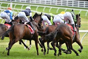 MELBOURNE, AUSTRALIA - OCTOBER 16: Brett Prebble riding Incentivise (R) in to the first turn before winning Race 9, the Carlton Draught Caulfield Cup, during Caulfield Cup Day at Caulfield Racecourse on October 16, 2021 in Melbourne, Australia. (Photo by Vince Caligiuri/Getty Images)