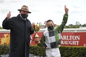 MELBOURNE, AUSTRALIA - OCTOBER 16: Brett Prebble and Trainer Peter Moody pose with the Caulfield Cup after Incentivise won Race 9, the Carlton Draught Caulfield Cup, during Caulfield Cup Day at Caulfield Racecourse on October 16, 2021 in Melbourne, Australia. (Photo by Vince Caligiuri/Getty Images)