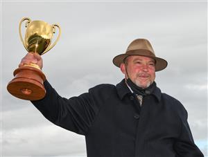 MELBOURNE, AUSTRALIA - OCTOBER 16: Trainer Peter Moody poses with the Caulfield Cup after Incentivise won Race 9, the Carlton Draught Caulfield Cup, during Caulfield Cup Day at Caulfield Racecourse on October 16, 2021 in Melbourne, Australia. (Photo by Vince Caligiuri/Getty Images)