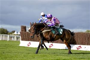 CHELTENHAM, ENGLAND - OCTOBER 22: Tom Cannon riding Annual Invictus (pink) clear the last to win The 888sport Novices' Limited Handicap Chase at Cheltenham Racecourse on October 22, 2021 in Cheltenham, England. (Photo by Alan Crowhurst/Getty Images)