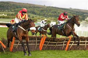 CHELTENHAM, ENGLAND - OCTOBER 22: Sam Twiston-Davies riding Guard Your Dreams (R, red) clear the last to win The Abu Dhabi Digital Exchange Handicap Hurdle at Cheltenham Racecourse on October 22, 2021 in Cheltenham, England. (Photo by Alan Crowhurst/Getty Images)