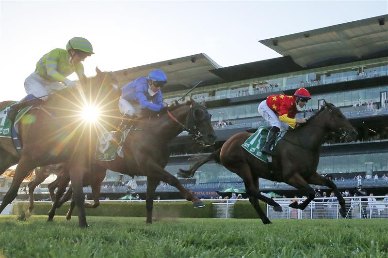 SYDNEY, AUSTRALIA - OCTOBER 23: Tommy Berry on Quantico (red) wins race 10 the Southern Cross Group Handicap during Sydney Racing at Royal Randwick Racecourse on October 23, 2021 in Sydney, Australia. (Photo by Mark Evans/Getty Images)