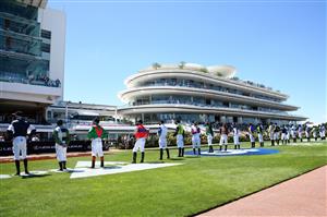 MELBOURNE, AUSTRALIA - NOVEMBER 02: Lexus Melbourne Cup jockeys are seen during the signing of the national anthem during 2021 Melbourne Cup Day at Flemington Racecourse on November 02, 2021 in Melbourne, Australia. (Photo by Vince Caligiuri/Getty Images)