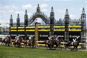 MELBOURNE, AUSTRALIA - NOVEMBER 02: The field pass the finish post for the first time in race 7, the Lexus Melbourne Cup during 2021 Melbourne Cup Day at Flemington Racecourse on November 02, 2021 in Melbourne, Australia. (Photo by Darrian Traynor/Getty Images)