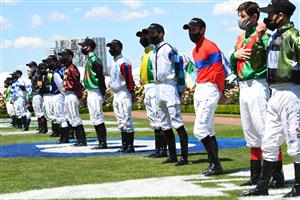 MELBOURNE, AUSTRALIA - NOVEMBER 02: Lexus Melbourne Cup jockeys are seen during the signing of the national anthem during 2021 Melbourne Cup Day at Flemington Racecourse on November 02, 2021 in Melbourne, Australia. (Photo by Vince Caligiuri/Getty Images)