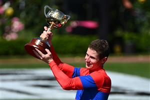 MELBOURNE, AUSTRALIA - NOVEMBER 02: James Mcdonald poses with the Lexus Melbourne Cup after winning race 7, the Lexus Melbourne Cup on #4 Verry Elleegant during 2021 Melbourne Cup Day at Flemington Racecourse on November 02, 2021 in Melbourne, Australia. (Photo by Quinn Rooney/Getty Images)