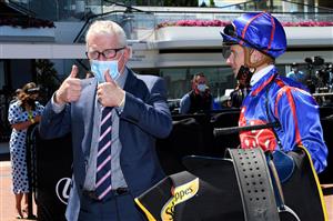 MELBOURNE, AUSTRALIA - NOVEMBER 02: James Mcdonald riding #1 Profiteer celebrates with trainer Mick Price after winning race 6, The Schweppervescence Plate during 2021 Melbourne Cup Day at Flemington Racecourse on November 02, 2021 in Melbourne, Australia. (Photo by Vince Caligiuri/Getty Images)