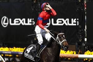 MELBOURNE, AUSTRALIA - NOVEMBER 02: James Mcdonald riding #4 Verry Elleegant celebrates winning race 7, the Lexus Melbourne Cup during 2021 Melbourne Cup Day at Flemington Racecourse on November 02, 2021 in Melbourne, Australia. (Photo by Darrian Traynor/Getty Images)