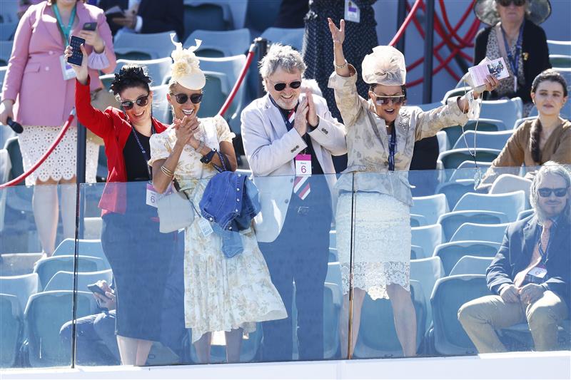 MELBOURNE, AUSTRALIA - NOVEMBER 04: Racegoers celebrate after race 6, the G.H.Mumm Century Stakes during 2021 Oaks Day at Flemington Racecourse on November 04, 2021 in Melbourne, Australia. (Photo by Daniel Pockett/Getty Images)