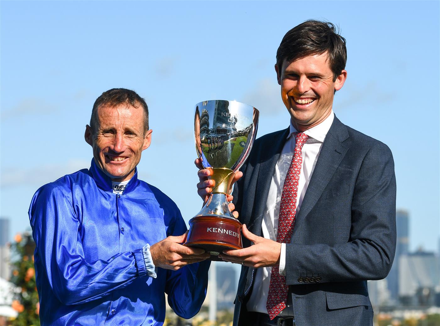 MELBOURNE, AUSTRALIA - NOVEMBER 04: Damien Oliver poses with Trainer James Cummings and trophy after riding Willowy to win Race 8, the Kennedy Oaks, during 2021 Oaks Day at Flemington Racecourse on November 04, 2021 in Melbourne, Australia. (Photo by Vince Caligiuri/Getty Images)