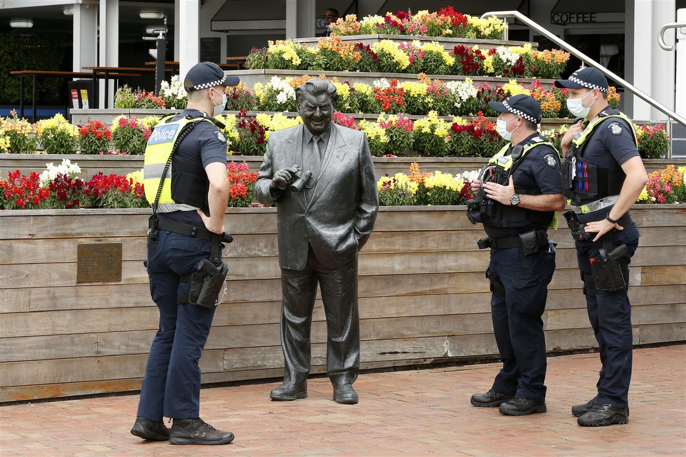 MELBOURNE, AUSTRALIA - NOVEMBER 04: Members of Victorian Police observe the statue of Bart Cummings during 2021 Oaks Day at Flemington Racecourse on November 04, 2021 in Melbourne, Australia. (Photo by Darrian Traynor/Getty Images)