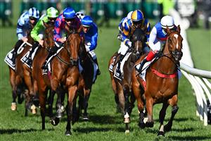 MELBOURNE, AUSTRALIA - NOVEMBER 04: The field gallop past the finish post for the first time in race 8, the Kennedy Oaks during 2021 Oaks Day at Flemington Racecourse on November 04, 2021 in Melbourne, Australia. (Photo by Quinn Rooney/Getty Images)