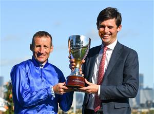 MELBOURNE, AUSTRALIA - NOVEMBER 04: Damien Oliver poses with Trainer James Cummings and trophy after riding Willowy to win Race 8, the Kennedy Oaks, during 2021 Oaks Day at Flemington Racecourse on November 04, 2021 in Melbourne, Australia. (Photo by Vince Caligiuri/Getty Images)