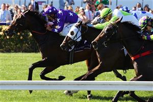 MELBOURNE, AUSTRALIA - NOVEMBER 04: Damien Oliver riding #9 Bermadez leads Jye McNeil riding #12 Typhoon Harmony to win race 7, the Melbourne Cup Carnival Country Final during 2021 Oaks Day at Flemington Racecourse on November 04, 2021 in Melbourne, Australia. (Photo by Robert Cianflone/Getty Images)