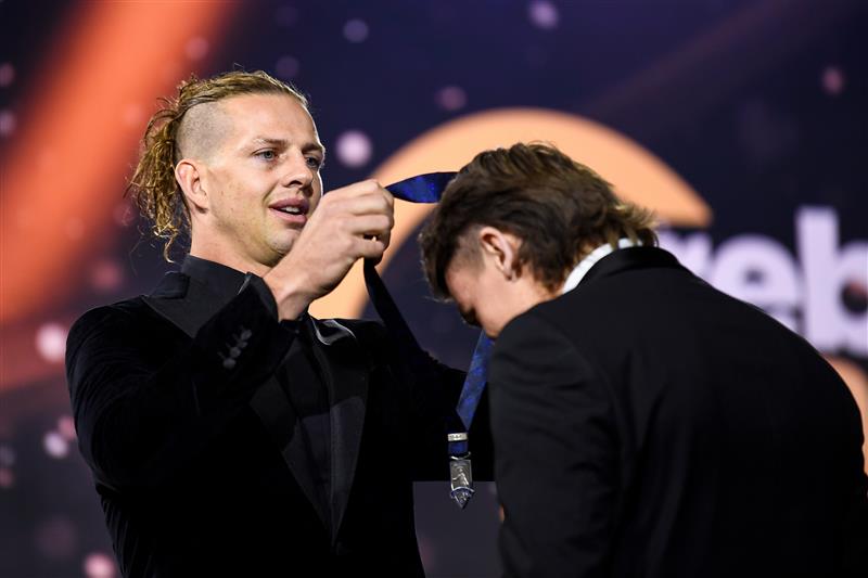 PERTH, AUSTRALIA - SEPTEMBER 19: Nat Fyfe presents the Goal of the Year award to Caleb Serong of the Dockers during the 2021 Brownlow Medal Count at Optus Stadium on September 19, 2021 in Perth, Australia. (Photo by Daniel Carson/AFL Photos via Getty Images)