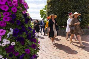 MELBOURNE, AUSTRALIA - NOVEMBER 06: Racegoers arrive during 2021 Paramount+ Stakes Day at Flemington Racecourse on November 06, 2021 in Melbourne, Australia. (Photo by Daniel Pockett/Getty Images)