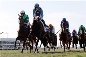 DEL MAR, CALIFORNIA - NOVEMBER 06: Jockey Umberto Rispoli aboard Smooth Like Strait leads the field to the first turn during the Breeders' Cup Mile at Del Mar Race Track on November 06, 2021 in Del Mar, California. (Photo by Rob Carr/Getty Images)