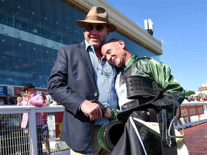 MELBOURNE, AUSTRALIA - NOVEMBER 27: Glen Boss is congratulated by Trainer Peter Moody after riding Spanish Mission to finish fourth in his last ever race ride in Race 7, the Herald Sun Zipping Classic, during Melbourne Racing at Caulfield Racecourse on November 27, 2021 in Melbourne, Australia. (Photo by Vince Caligiuri/Getty Images)