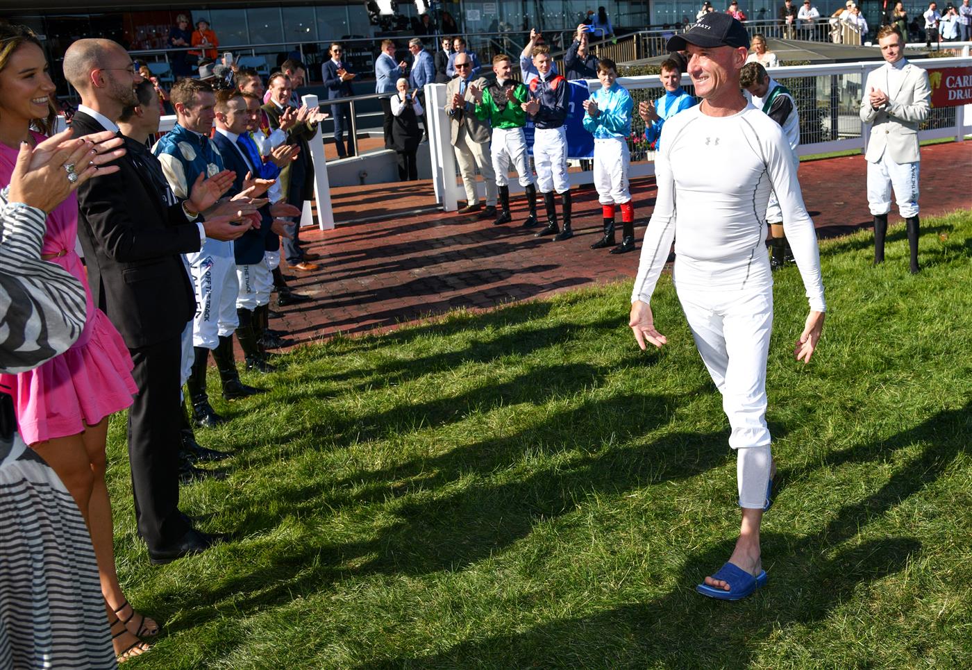 MELBOURNE, AUSTRALIA - NOVEMBER 27: Glen Boss is given a guard of honour after riding Spanish Mission to finish fourth in his last ever race ride in Race 7, the Herald Sun Zipping Classic, during Melbourne Racing at Caulfield Racecourse on November 27, 2021 in Melbourne, Australia. (Photo by Vince Caligiuri/Getty Images)