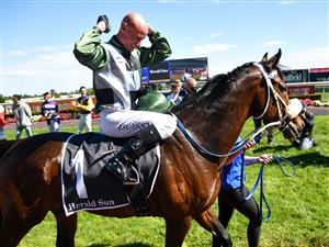 MELBOURNE, AUSTRALIA - NOVEMBER 27: Glen Boss riding Spanish Mission reacts in his last ever race ride after finishing 4th in Race 7, the Herald Sun Zipping Classic, during Melbourne Racing at Caulfield Racecourse on November 27, 2021 in Melbourne, Australia. (Photo by Vince Caligiuri/Getty Images)