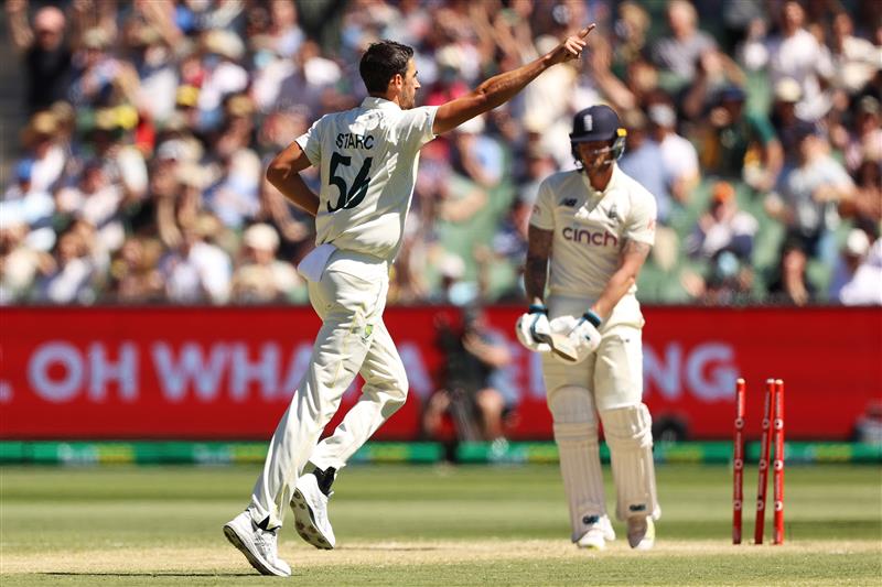 MELBOURNE, AUSTRALIA - DECEMBER 28: Mitchell Starc of Australia celebrates after bowling out Ben Stokes (R) of England during day three of the Third Test match in the Ashes series between Australia and England at Melbourne Cricket Ground on December 28, 2021 in Melbourne, Australia. (Photo by Robert Cianflone/Getty Images)