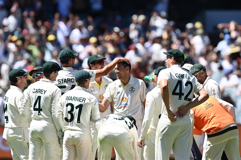 MELBOURNE, AUSTRALIA - DECEMBER 28: Scott Boland of Australia celebrates with teammates after dismissing Mark Wood of England during day three of the Third Test match in the Ashes series between Australia and England at Melbourne Cricket Ground on December 28, 2021 in Melbourne, Australia. (Photo by Quinn Rooney/Getty Images)