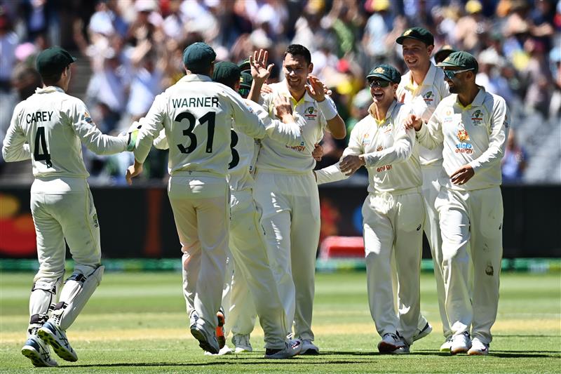 MELBOURNE, AUSTRALIA - DECEMBER 28: Scott Boland of Australia celebrates with teammates after dismissing Mark Wood of England during day three of the Third Test match in the Ashes series between Australia and England at Melbourne Cricket Ground on December 28, 2021 in Melbourne, Australia. (Photo by Quinn Rooney/Getty Images)