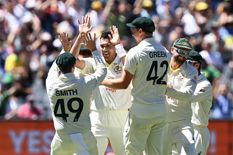 MELBOURNE, AUSTRALIA - DECEMBER 28: Scott Boland of Australia celebrates with teammates after dismissing Mark Wood of England during day three of the Third Test match in the Ashes series between Australia and England at Melbourne Cricket Ground on December 28, 2021 in Melbourne, Australia. (Photo by Quinn Rooney/Getty Images)