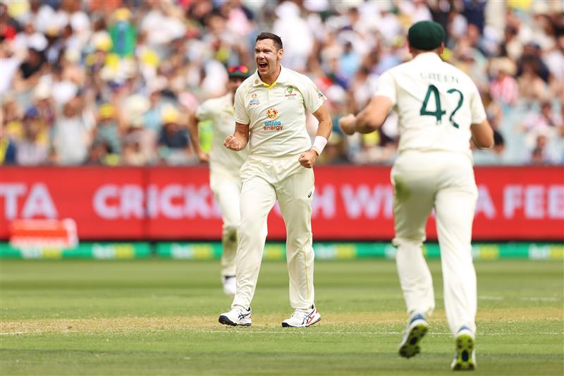 MELBOURNE, AUSTRALIA - DECEMBER 26: Scott Boland of Australia takes his first test wicket dismissing Mark Wood of England during day one of the Third Test match in the Ashes series between Australia and England at Melbourne Cricket Ground on December 26, 2021 in Melbourne, Australia. (Photo by Robert Cianflone/Getty Images)