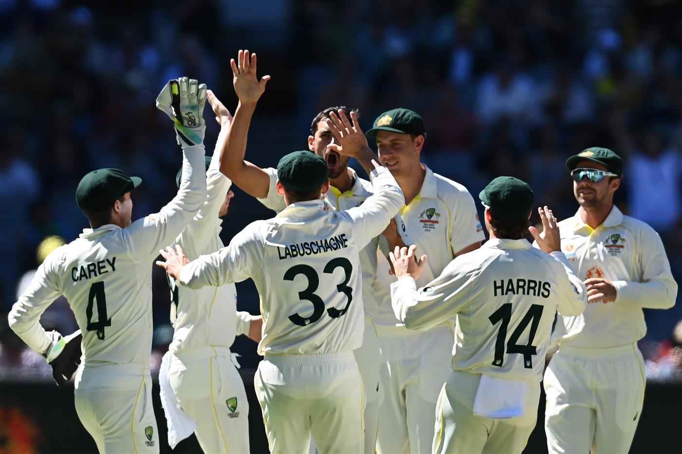 MELBOURNE, AUSTRALIA - DECEMBER 28: Mitchell Starc (C) of Australia celebrates with teammates after bowling out Ben Stokes of England during day three of the Third Test match in the Ashes series between Australia and England at Melbourne Cricket Ground on December 28, 2021 in Melbourne, Australia. (Photo by Quinn Rooney/Getty Images)
