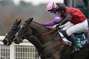 ASCOT, ENGLAND - JANUARY 22: David Maxwell riding Cat Tiger (red) clear the last to win The SBK Handicap Chase from Jonjo O'Neill Jr and Cobolobo (purple) at Ascot Racecourse on January 22, 2022 in Ascot, England. (Photo by Alan Crowhurst/Getty Images)