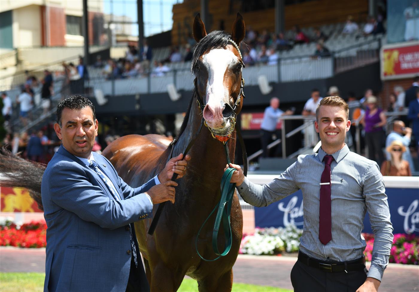 MELBOURNE, AUSTRALIA - FEBRUARY 12: Trainer Julius Sandhu (L) poses with Lofty Strike after winning Race 3, the Neds Blue Diamond Prelude C&g, during Melbourne Racing at Caulfield Racecourse on February 12, 2022 in Melbourne, Australia. (Photo by Vince Caligiuri/Getty Images)
