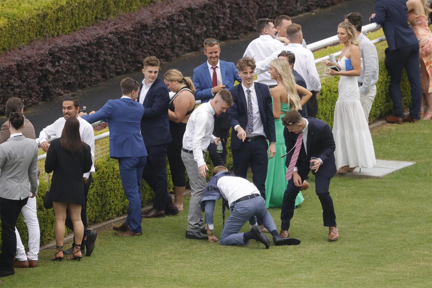 SYDNEY, AUSTRALIA - FEBRUARY 12: A man falls over as a rain shower hits during Sydney Racing at Royal Randwick Racecourse on February 12, 2022 in Sydney, Australia. (Photo by Jenny Evans/Getty Images)