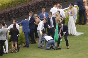 SYDNEY, AUSTRALIA - FEBRUARY 12: A man falls over as a rain shower hits during Sydney Racing at Royal Randwick Racecourse on February 12, 2022 in Sydney, Australia. (Photo by Jenny Evans/Getty Images)