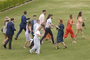 SYDNEY, AUSTRALIA - FEBRUARY 12: Racegoers take shelter from a rain shower during Sydney Racing at Royal Randwick Racecourse on February 12, 2022 in Sydney, Australia. (Photo by Jenny Evans/Getty Images)