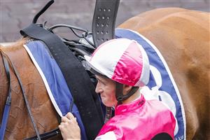 SYDNEY, AUSTRALIA - FEBRUARY 19: Tom Sherry unsaddles Expat after winning race 4 the Rosehill Bowling Club Millie Fox Stakes during Sydney Racing at Rosehill Gardens on February 19, 2022 in Sydney, Australia. (Photo by Jenny Evans/Getty Images)