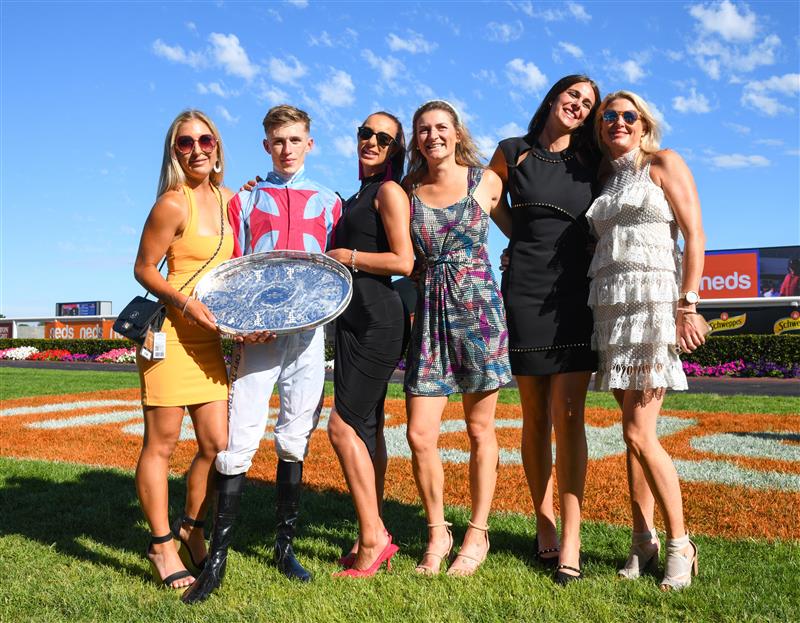 MELBOURNE, AUSTRALIA - FEBRUARY 26: Ben Allen poses with stable staff after riding Marabi to win Race 8,  the Neds Oakleigh Plate, during Melbourne Racing at Caulfield Racecourse on February 26, 2022 in Melbourne, Australia. (Photo by Vince Caligiuri/Getty Images)