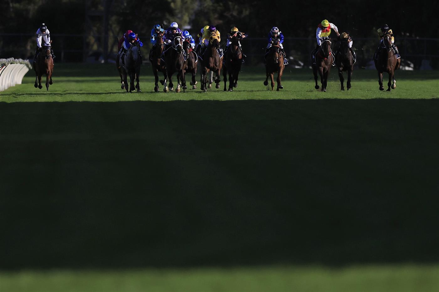 SYDNEY, AUSTRALIA - MARCH 12: Tommy Berry on Rousseau (white cap) wins race 10 the Corrine Handicap during Sydney Racing Chandon Ladies Day at Rosehill Gardens on March 12, 2022 in Sydney, Australia. (Photo by Mark Evans/Getty Images)
