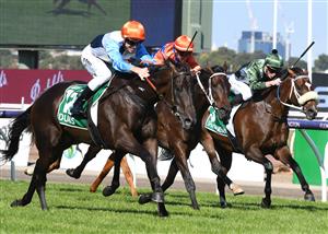 MELBOURNE, AUSTRALIA - MARCH 12: Josh Parr riding Duais defeat Think it Over and Spanish Mission in Race 7, the Tab Australian Cup, during Melbourne Racing at Flemington Racecourse on March 12, 2022 in Melbourne, Australia. (Photo by Vince Caligiuri/Getty Images)
