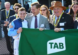 MELBOURNE, AUSTRALIA - MARCH 12: Josh Parr poses with trainer Ed Cummings after winning Race 7, the Tab Australian Cup, during Melbourne Racing at Flemington Racecourse on March 12, 2022 in Melbourne, Australia. (Photo by Vince Caligiuri/Getty Images)