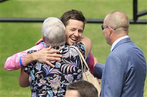 SYDNEY, AUSTRALIA - MARCH 12: Jason Collett hug owners of Just Folk after winning race 4 the Hyland Race Colours Ajax Stakes during Sydney Racing Chandon Ladies Day at Rosehill Gardens on March 12, 2022 in Sydney, Australia. (Photo by Mark Evans/Getty Images)