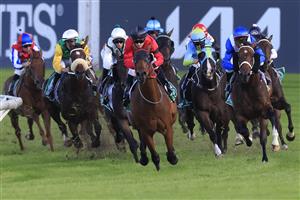 SYDNEY, AUSTRALIA - MARCH 12: Tyler Schiller on Taksu (red) leads the field at the home turn to win race 9 the Vale Alan Brown AM Handicap during Sydney Racing Chandon Ladies Day at Rosehill Gardens on March 12, 2022 in Sydney, Australia. (Photo by Mark Evans/Getty Images)