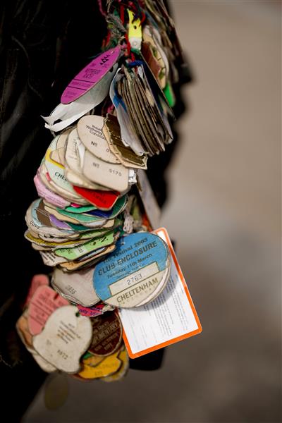 CHELTENHAM, ENGLAND - MARCH 15: A racegoer with badges from many days racing throughout the years on day one of The Festival at Cheltenham Racecourse on March 15, 2022 in Cheltenham, England. (Photo by Alan Crowhurst/Getty Images)