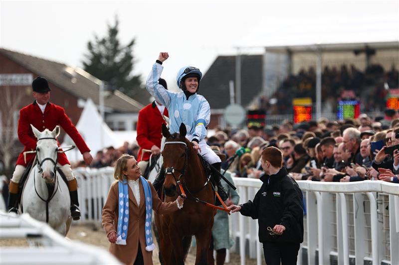 Jockey Rachael Blackmore (C) reacts as she returns to the winner's enclosure after her victory on Honeysuckle in the Champion Hurdle on the first day of the Cheltenham Festival at Cheltenham Racecourse, in Cheltenham, England on March 15, 2022. (Photo by Adrian DENNIS / AFP) (Photo by ADRIAN DENNIS/AFP via Getty Images)