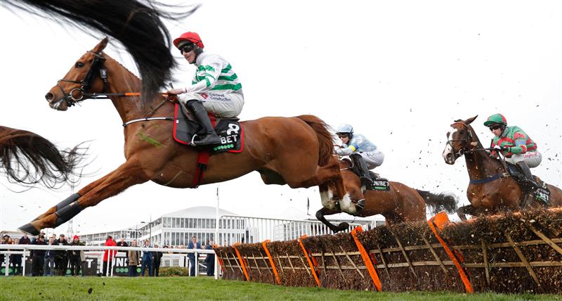 Jockey Jack Kennedy and Zanahiyr jump a hurdle during the Champion Hurdle on the first day of the Cheltenham Festival at Cheltenham Racecourse, in Cheltenham, England on March 15, 2022. (Photo by Adrian DENNIS / AFP) (Photo by ADRIAN DENNIS/AFP via Getty Images)
